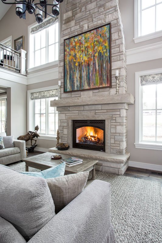 Stone fireplace in a living room with tall windows, Park City, Utah