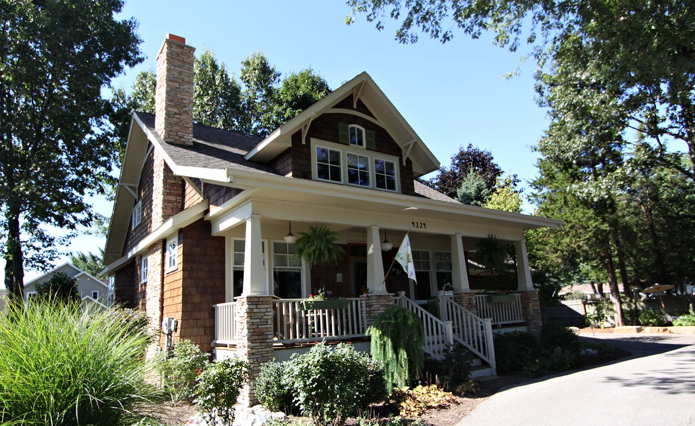 Cedar-shingle bungalow with stone chimney and front porch, Southwest Michigan
