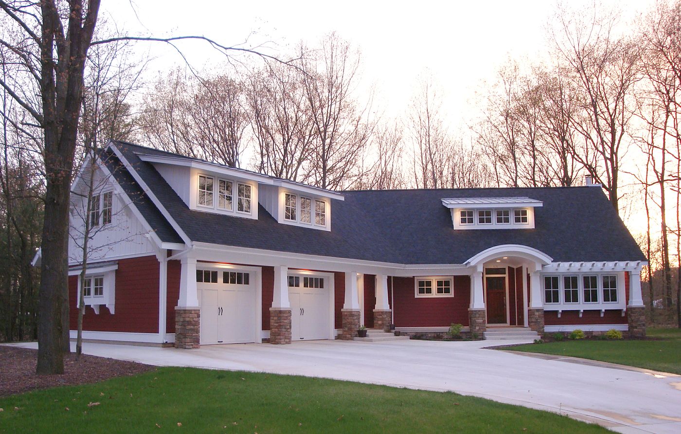 Red Craftsman home with garage at dusk, West Michigan